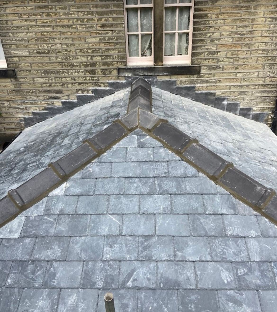 Repointed stone slate ridge and hips on a Yorkshire stone house