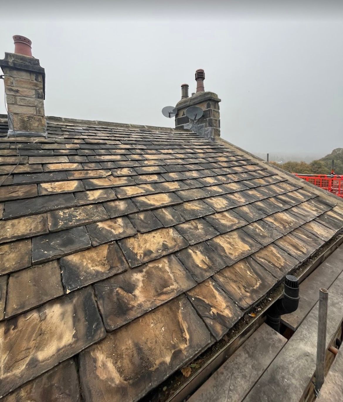 Weathered Yorkshire stone slate roof inspected before re-slating