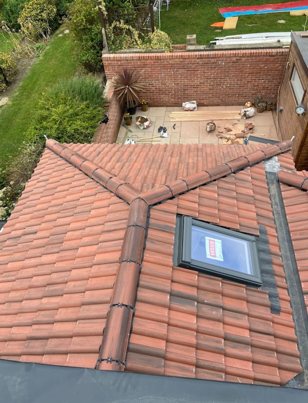 New clay pantile roof with Velux window and lead-lined hips on an extension