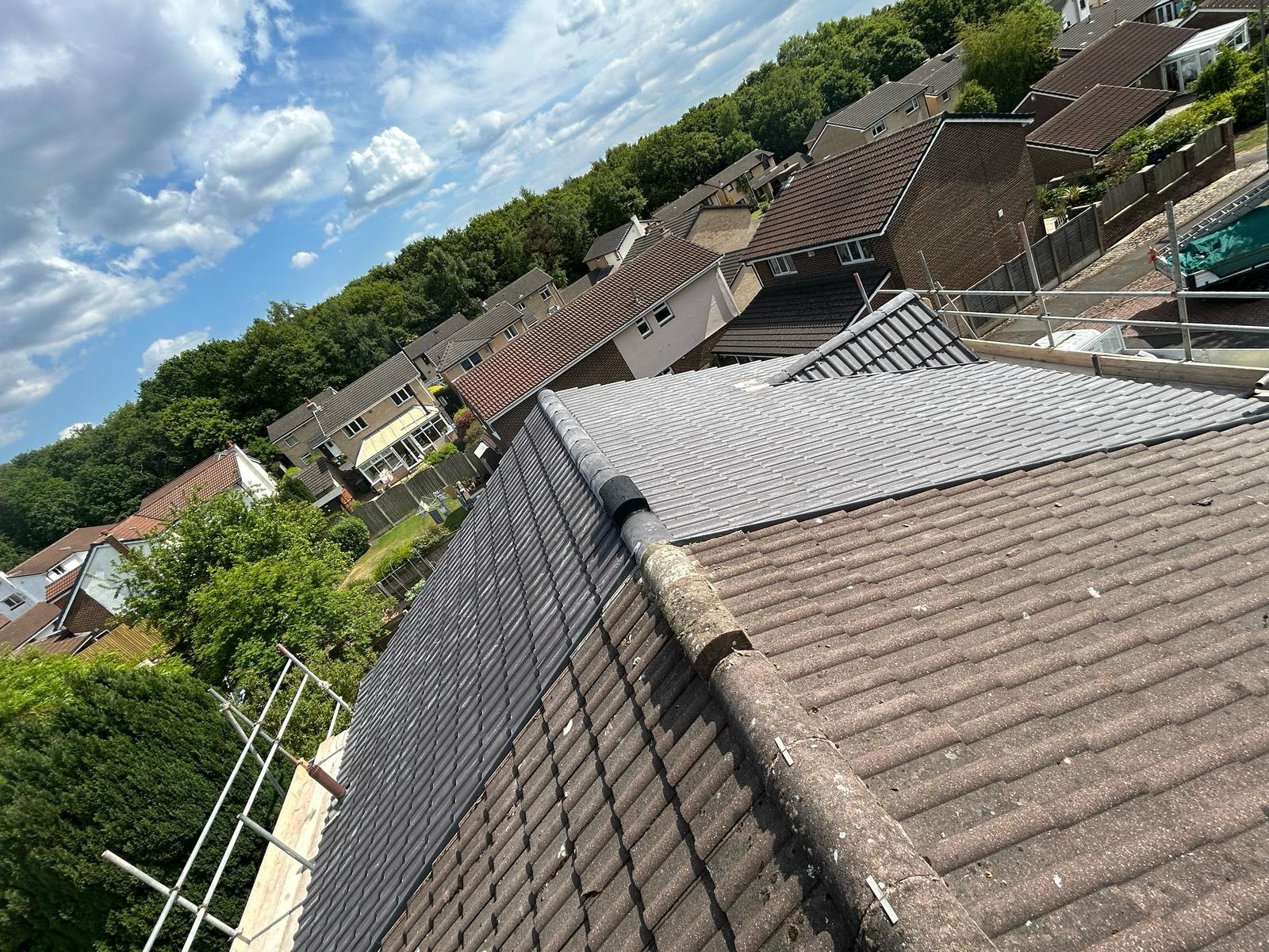 Completed grey tiled pitched roof overlooking a Yorkshire valley after a full re-roof